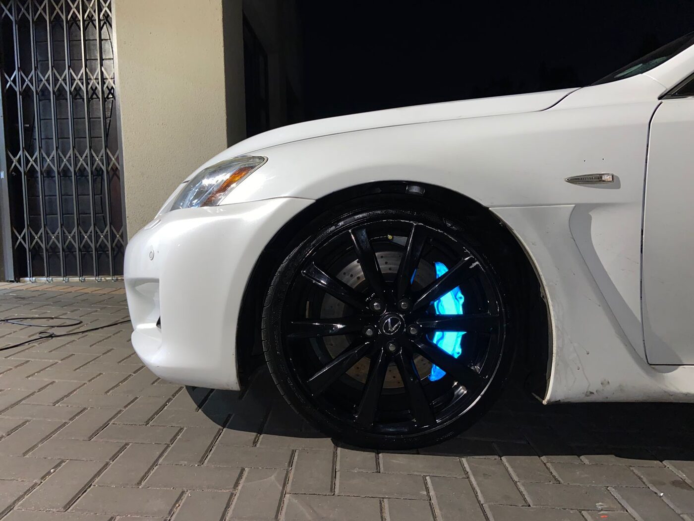 Brake caliper glowing icy blue behind a black alloy wheel